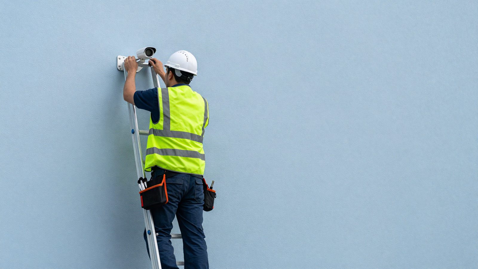 Technician installing a CCTV camera